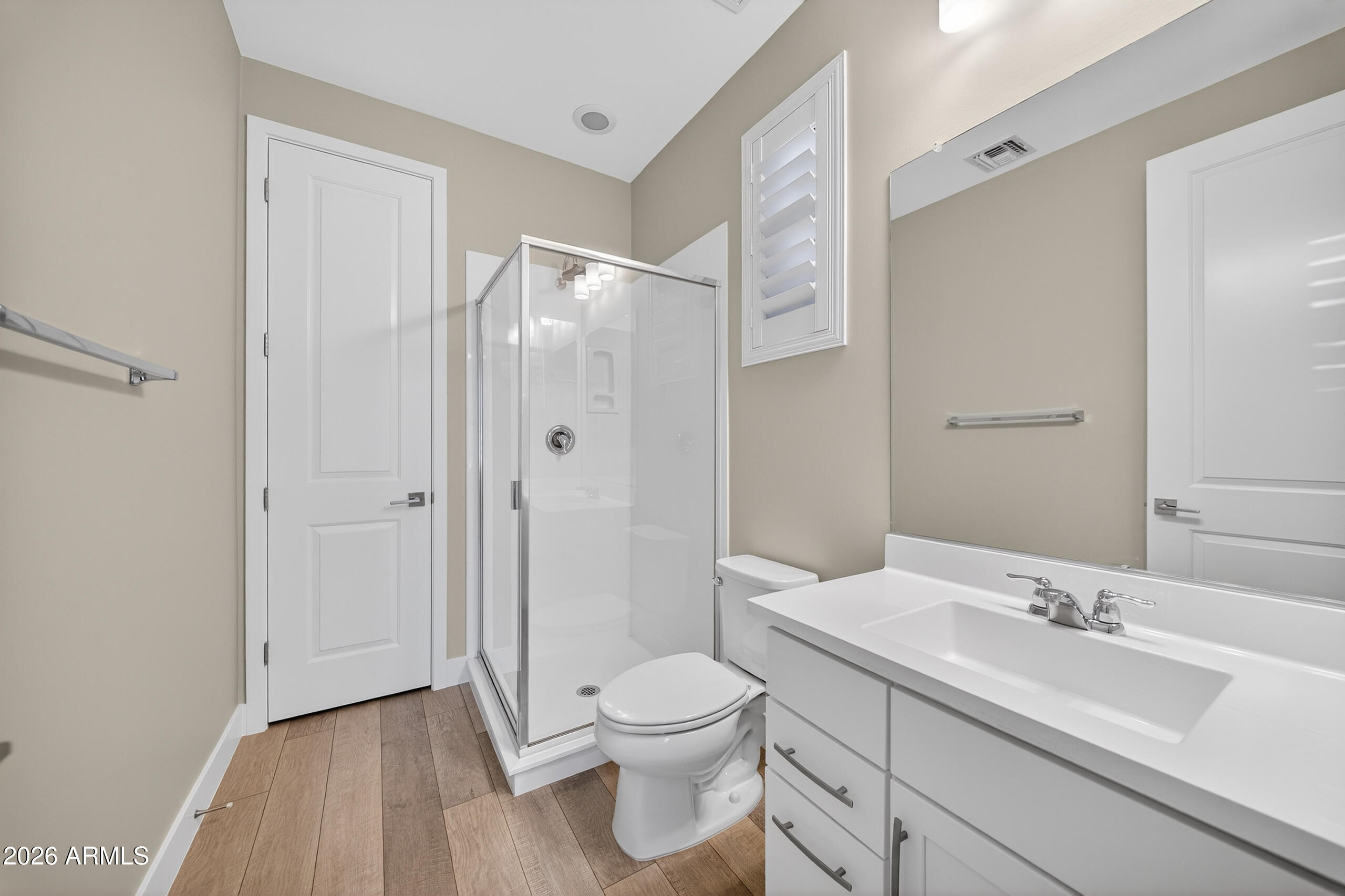 5067 South Girard Street Gilbert, AZ 85298 - Photo 11 of 15 a bathroom with a toilet a sink and a large mirror
