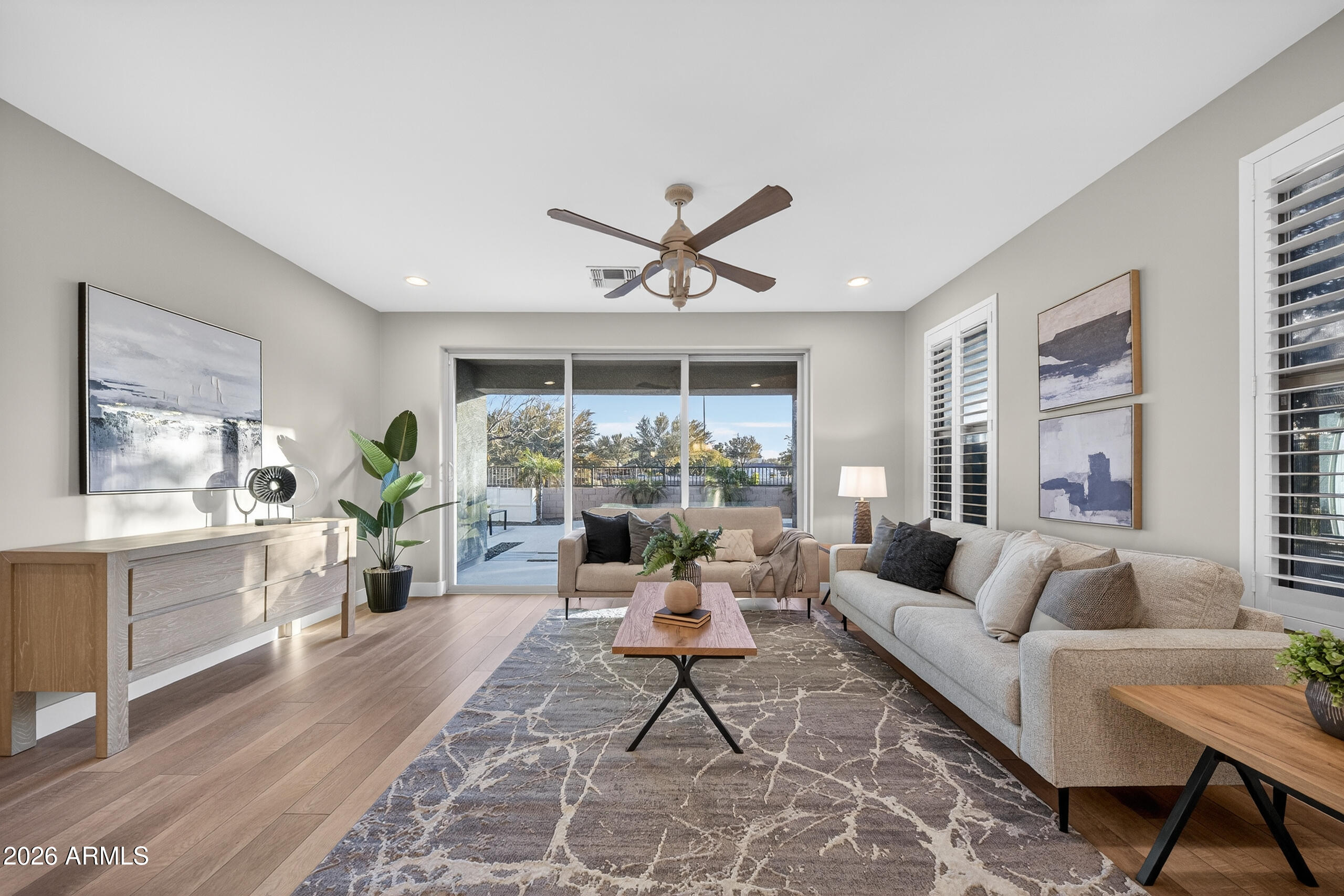 5067 South Girard Street Gilbert, AZ 85298 - Photo 2 of 15 a living room with furniture a chandelier and a large window