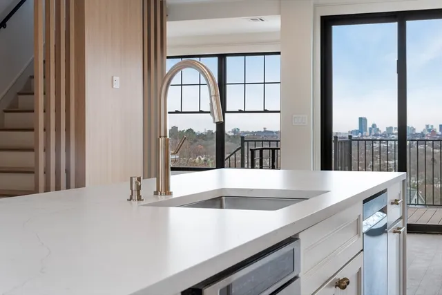 a view of a kitchen with granite countertop a sink and a large window