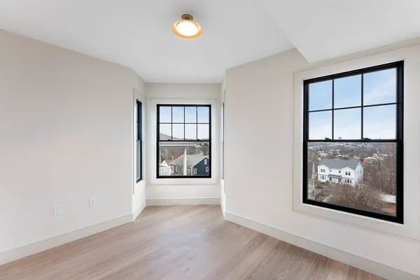 an empty room with windows and entrance