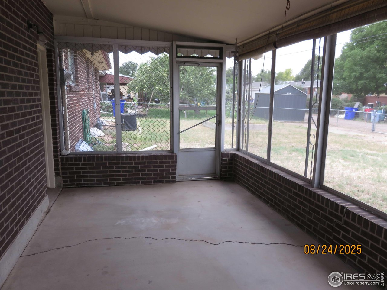 425 35th Court Greeley, CO 80634 - Photo 31 of 36 a view of a glass door with a yard from a window