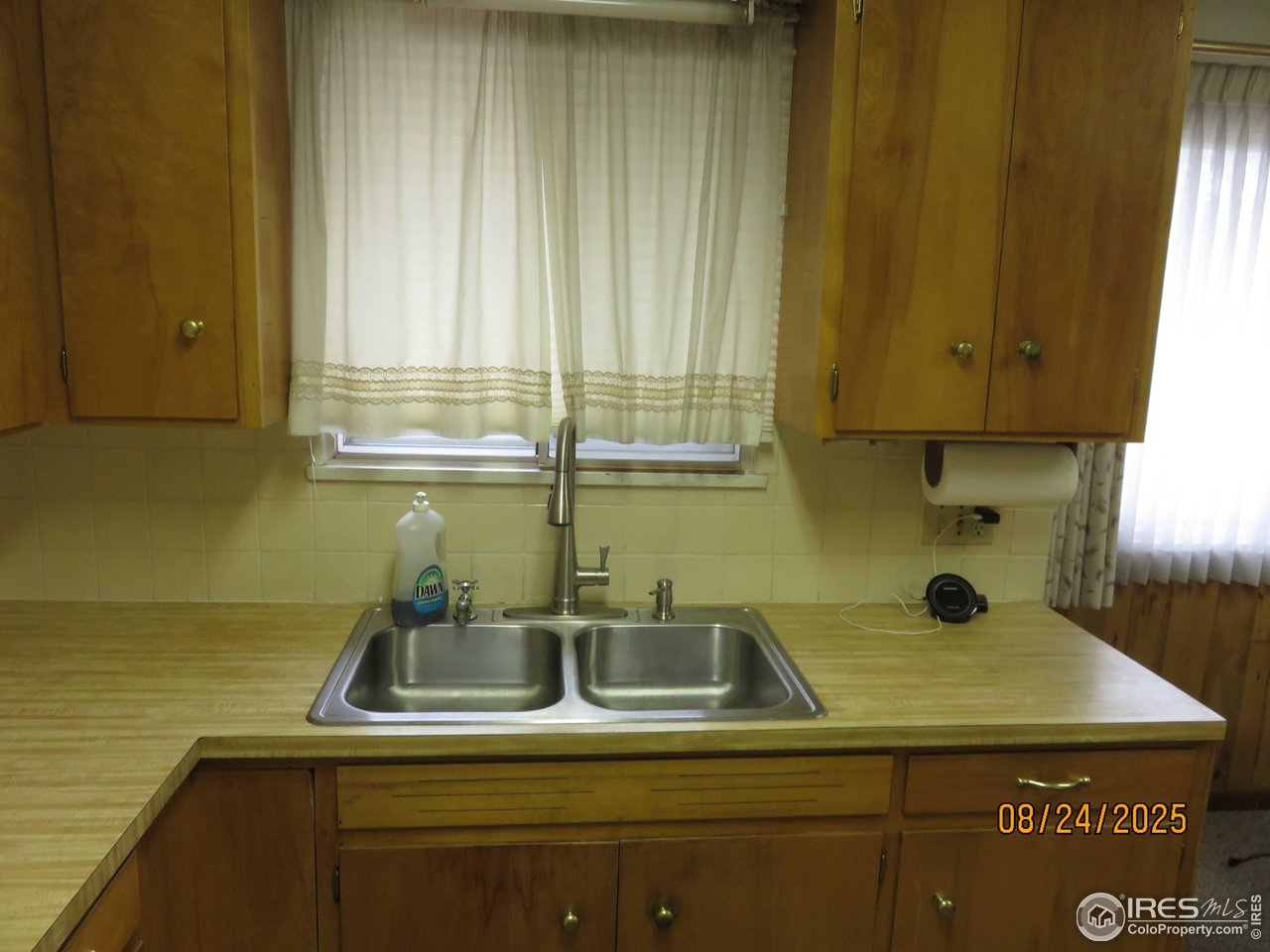 425 35th Court Greeley, CO 80634 - Photo 9 of 36 a view of a kitchen with a sink and cabinets