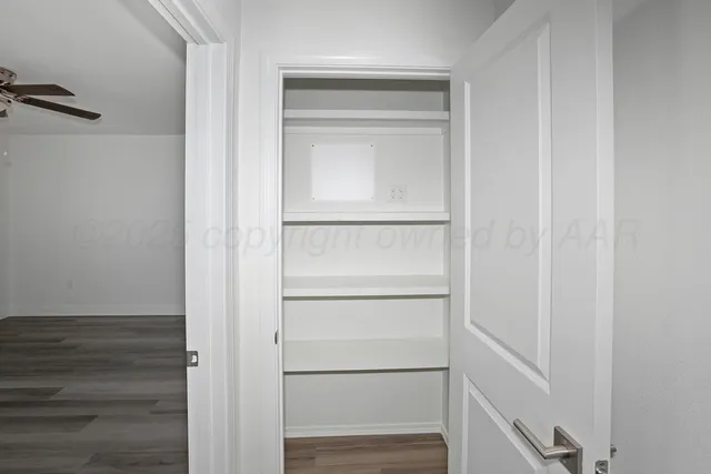 a view of walk in closet with empty racks