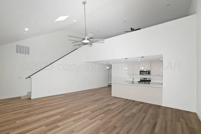 a view of a kitchen with a sink and a stove top oven
