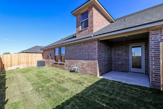a view of a house with a yard and garage