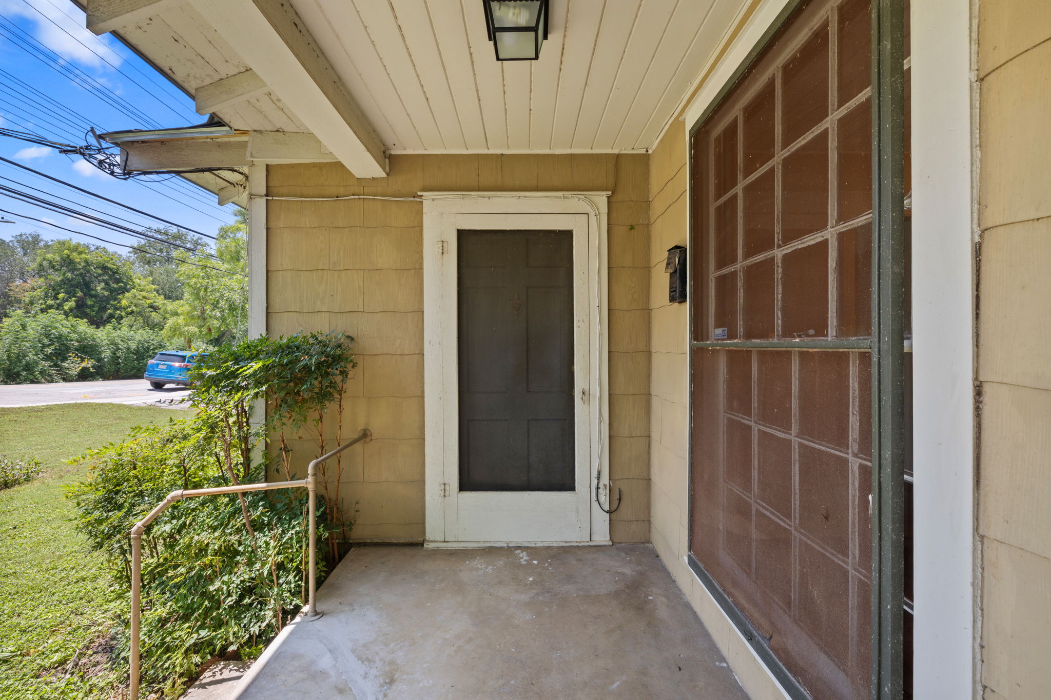 3704 Cherrywood Road Austin, TX 78722 - Photo 5 of 40 Entry to the home with a big picture window and screen door.