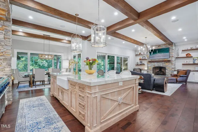 a view of a dining room with furniture a chandelier and wooden floor