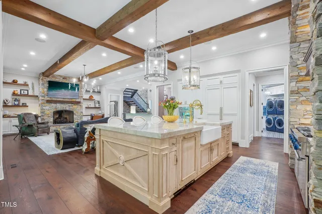 a kitchen with stainless steel appliances granite countertop a refrigerator and a sink