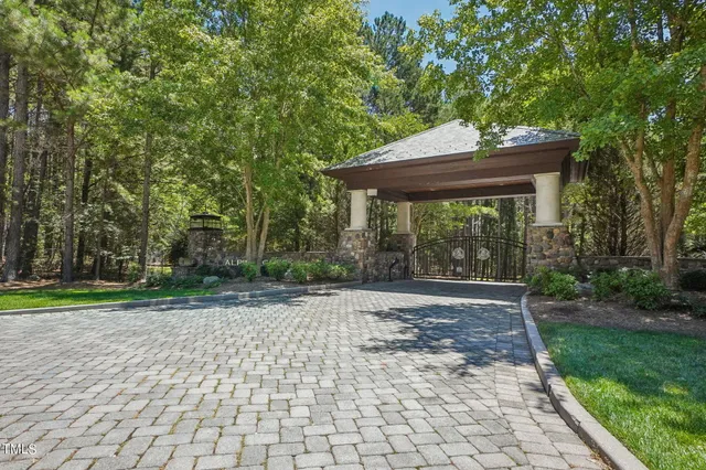 a view of a patio with table and chairs under an umbrella