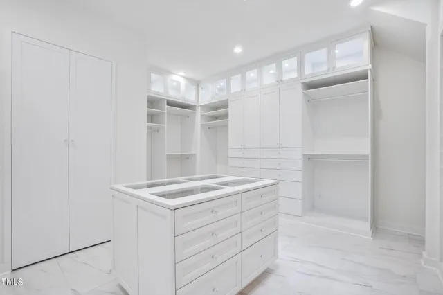 a dining room with wooden floor a chandelier a wooden table and chairs