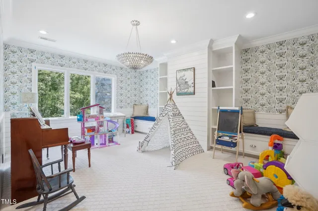 a living room with furniture a flat screen tv and a floor to ceiling window