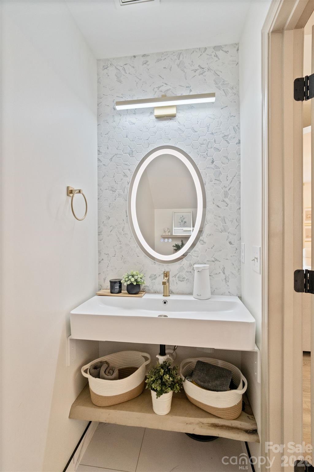 8726 Conrad Street Locust, NC 28097 - Photo 13 of 36 a bathroom with a sink and a mirror