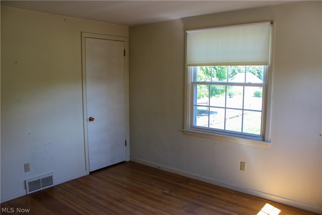11910 West Lake Road Vermilion, OH 44089 - Photo 14 of 28 Bedroom with natural hardwood flooring and a healthy amount of sunlight