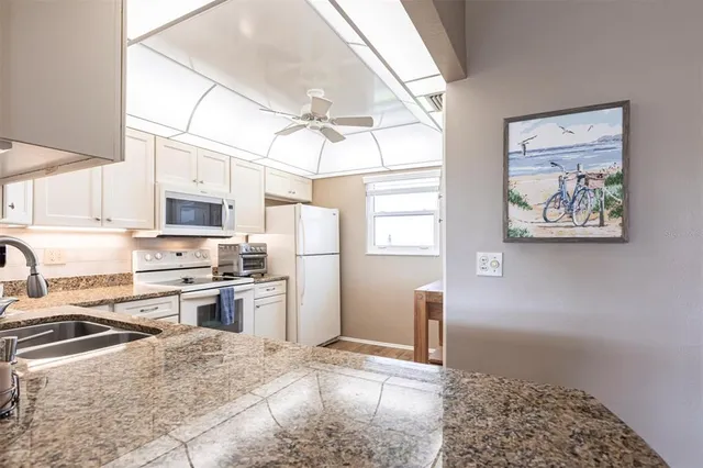 a kitchen with a refrigerator stove and sink