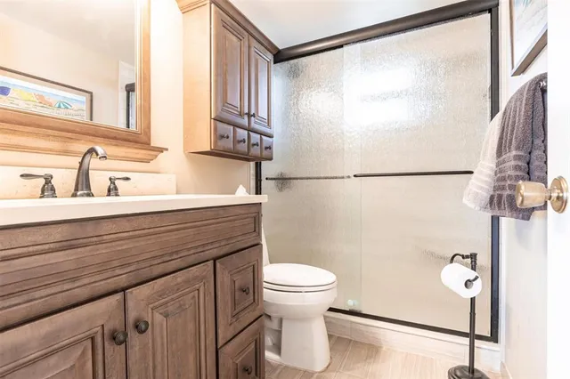 a bathroom with a sink toilet and a mirror