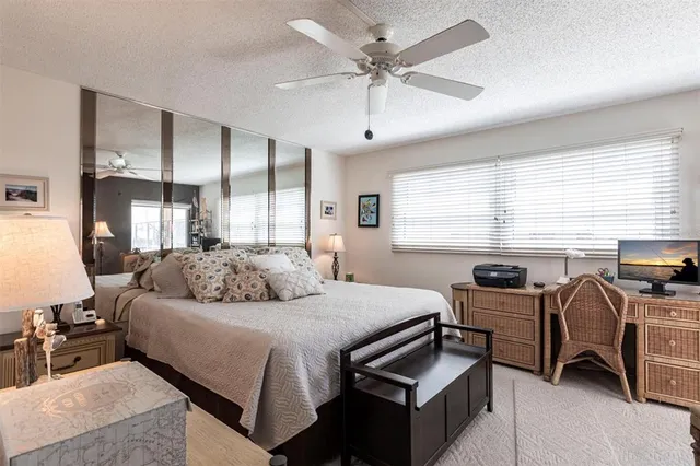 a bedroom with furniture and a large window