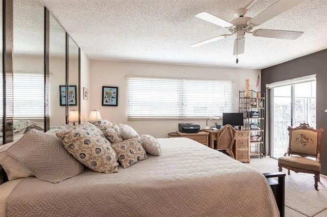 a bedroom with a large bed and a large window