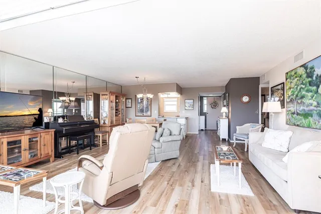 a living room with fireplace furniture and a wooden floor