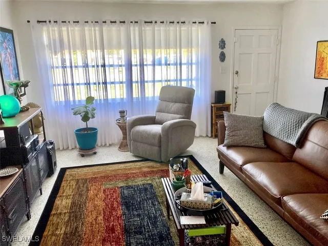 a living room with furniture and a rug