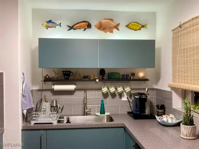 a kitchen with a sink and a stove