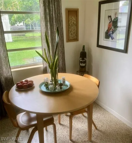 a view of a dining room with furniture window and outside view