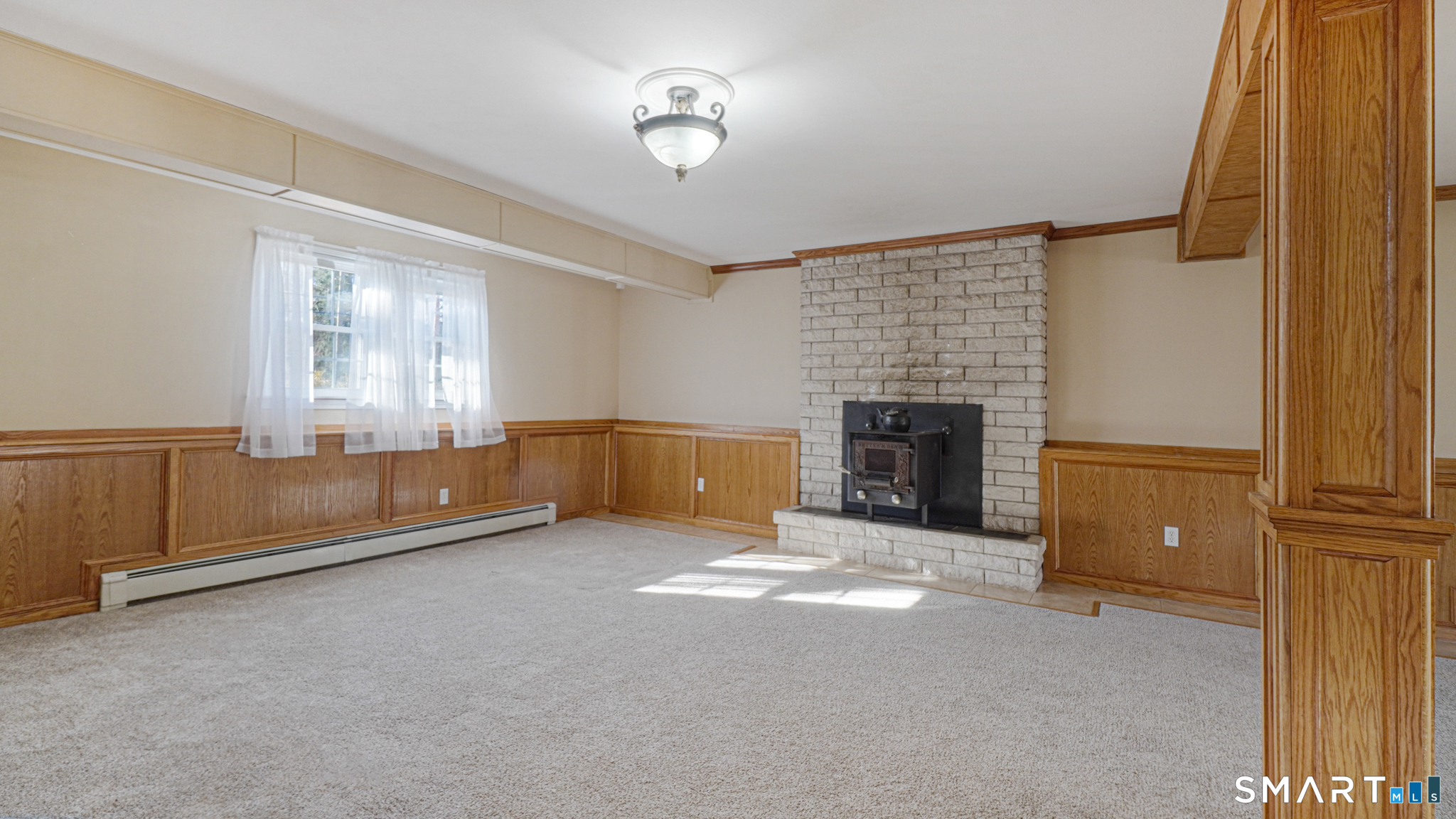 997 Meriden Avenue Southington, CT 06489 - Photo 13 of 24 a view of an empty room with a fireplace and a window