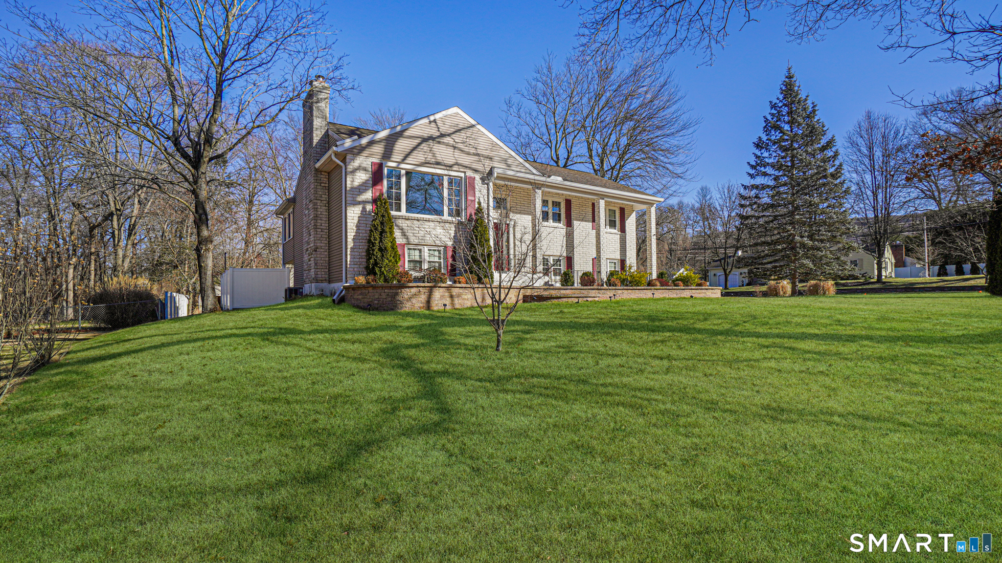 997 Meriden Avenue Southington, CT 06489 - Photo 22 of 24 a front view of a house with a yard table and chairs