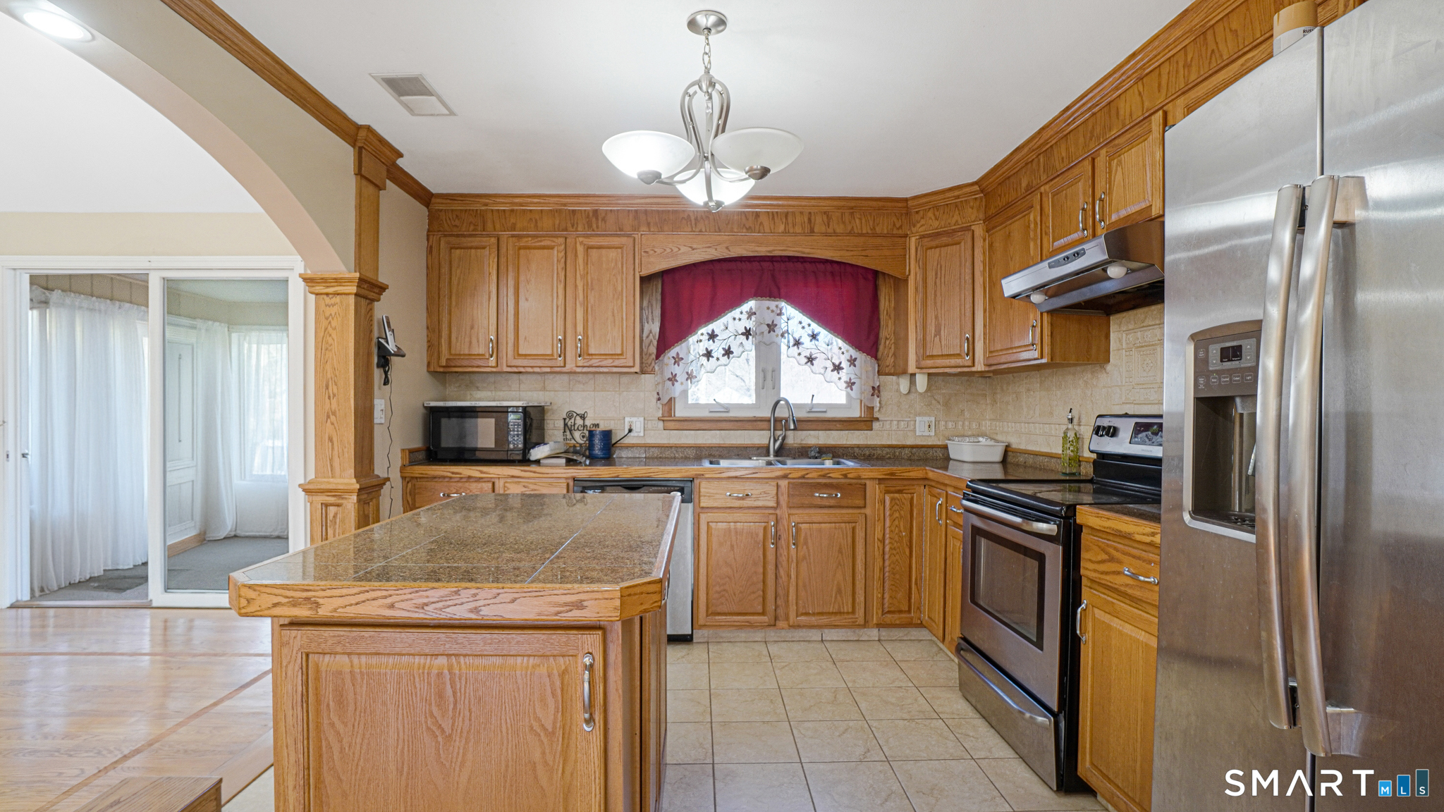 997 Meriden Avenue Southington, CT 06489 - Photo 6 of 24 a kitchen with stainless steel appliances granite countertop a stove refrigerator and cabinets