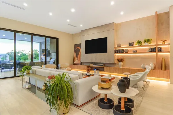 a living room with furniture and a floor to ceiling window