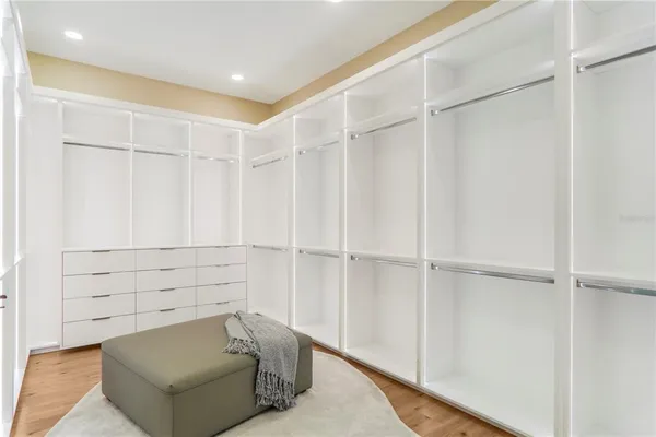 a bedroom with two beds and large windows