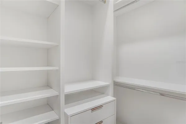 a living room with patio furniture and a flat screen tv