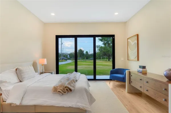 a living room with furniture kitchen view and a large window