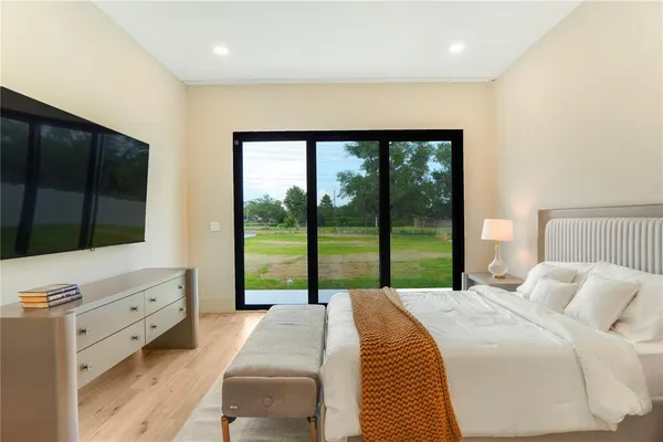 an aerial view of a house with a swimming pool and outdoor seating