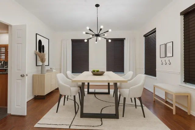 a view of a livingroom with wooden floor and chandelier
