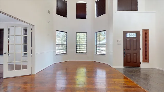 a living room with furniture a flat screen tv and a large window