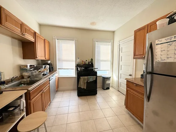 a kitchen with a refrigerator a stove a sink a washer and dryer