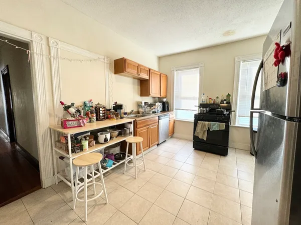 a kitchen with stainless steel appliances a refrigerator and a stove top oven