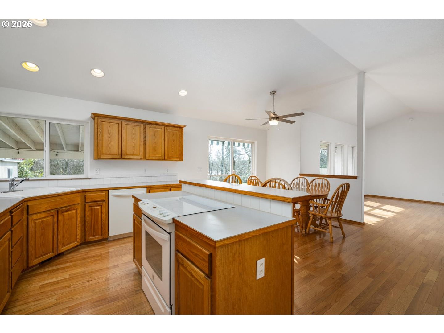 52364 Northeast 14th Scappoose, OR 97056 - Photo 16 of 42 a kitchen with a stove a sink dishwasher and a refrigerator with wooden floor