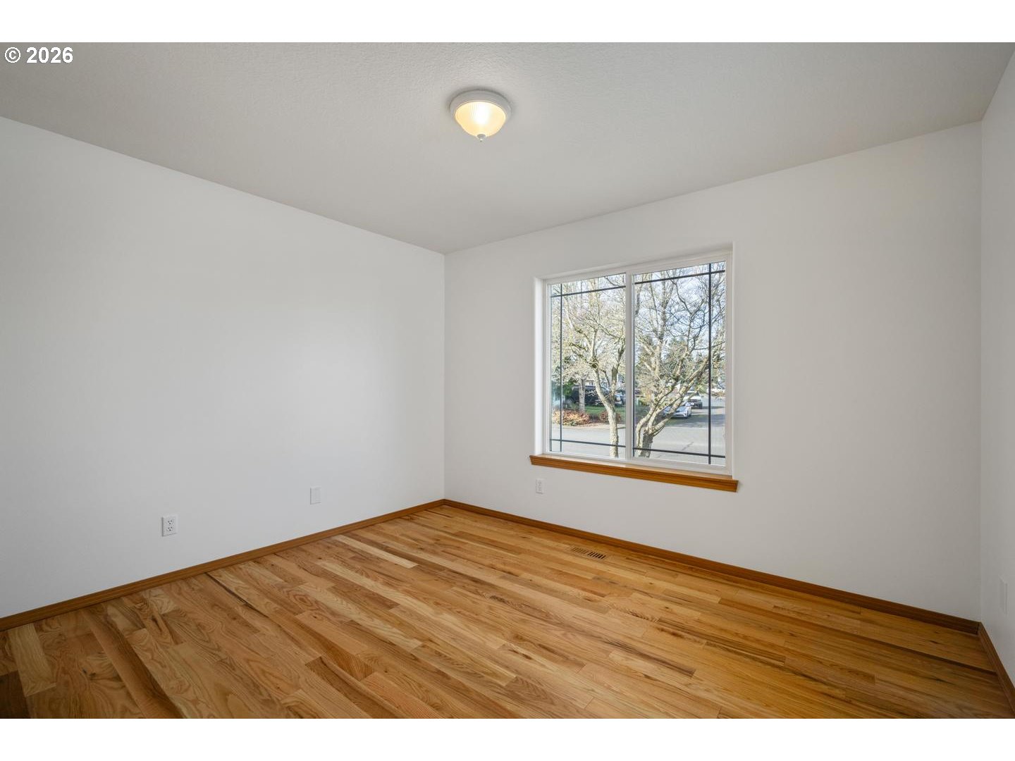 52364 Northeast 14th Scappoose, OR 97056 - Photo 31 of 42 a view of an empty room with a window and wooden floor