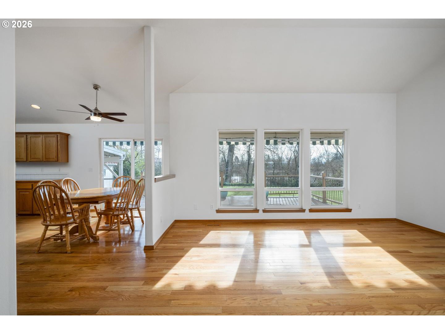 52364 Northeast 14th Scappoose, OR 97056 - Photo 7 of 42 a view of dining room and livingroom with furniture wooden floor a flat screen tv