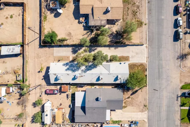an aerial view of residential houses with outdoor space