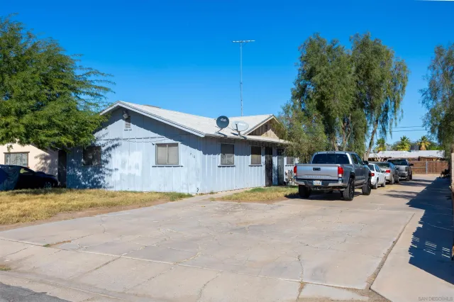 a view of a house with a cars park in front of a house