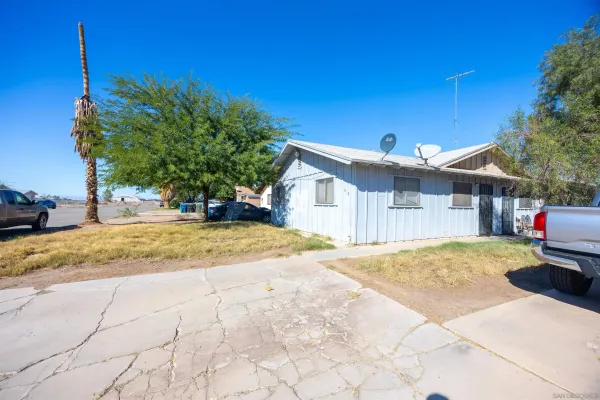 a view of a house with snow on the road