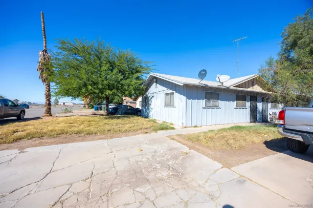 a view of a house with snow on the road