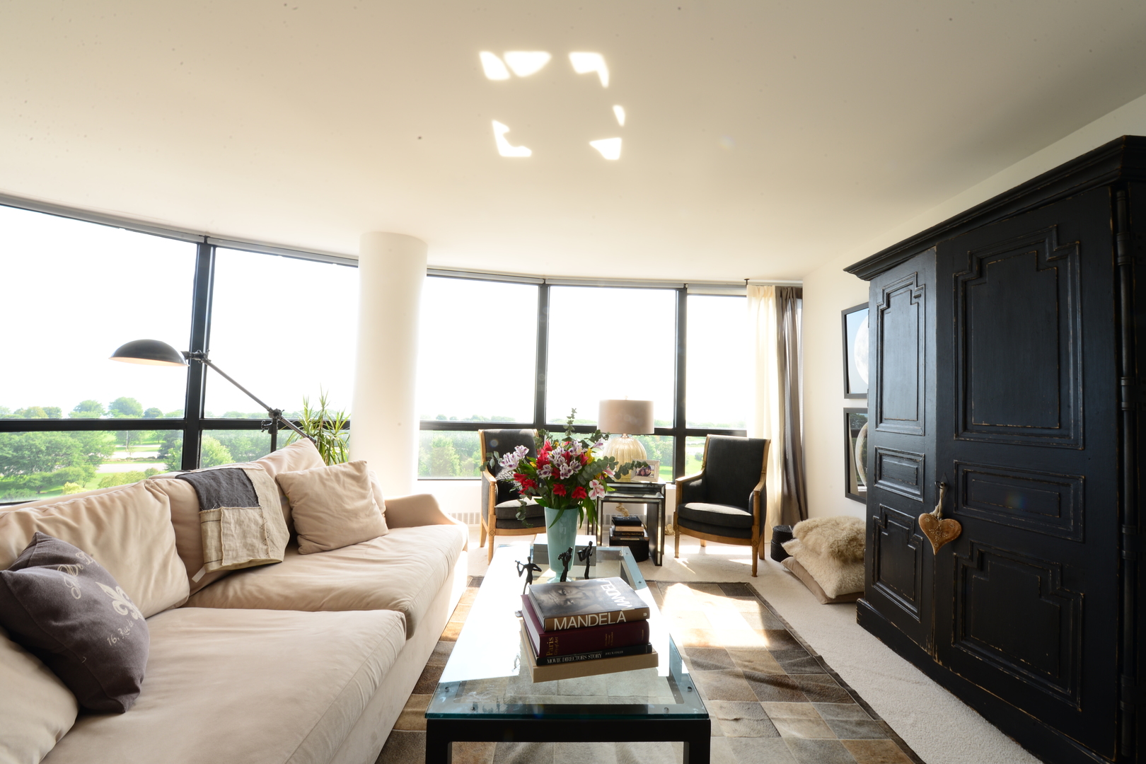 5415 North Sheridan Road, Unit 806 Chicago, IL 60640 - Photo 2 of 16 a living room with furniture and large windows