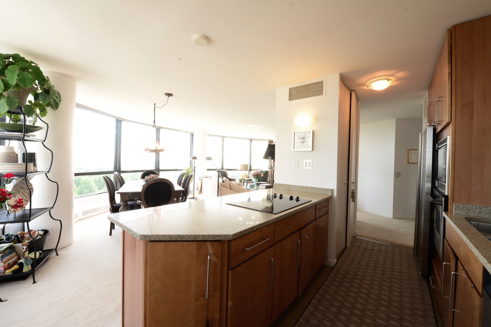 5415 North Sheridan Road, Unit 806 Chicago, IL 60640 - Photo 7 of 16 a kitchen with kitchen island a sink and a refrigerator