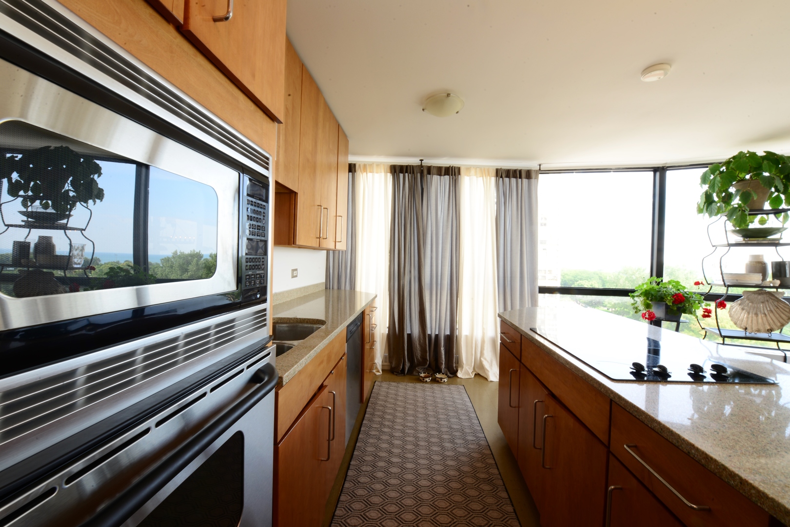 5415 North Sheridan Road, Unit 806 Chicago, IL 60640 - Photo 8 of 16 a kitchen with stainless steel appliances a sink and cabinets