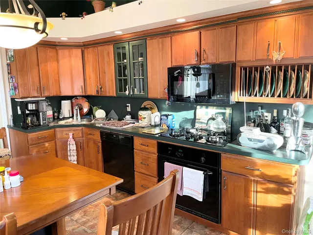 a kitchen with a stove a sink and a dining table