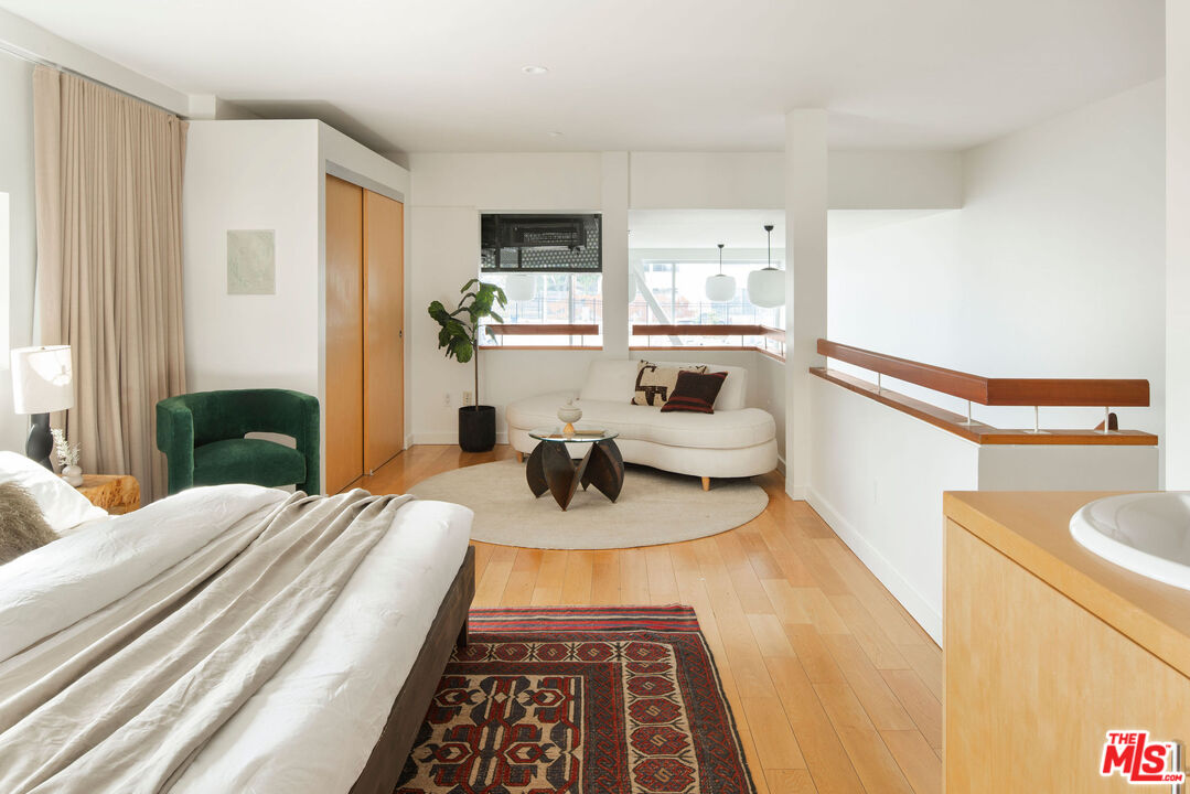 615 Hampton Drive, Unit A101 Venice, CA 90291 - Photo 14 of 24 a bedroom with a bed and a view of living room