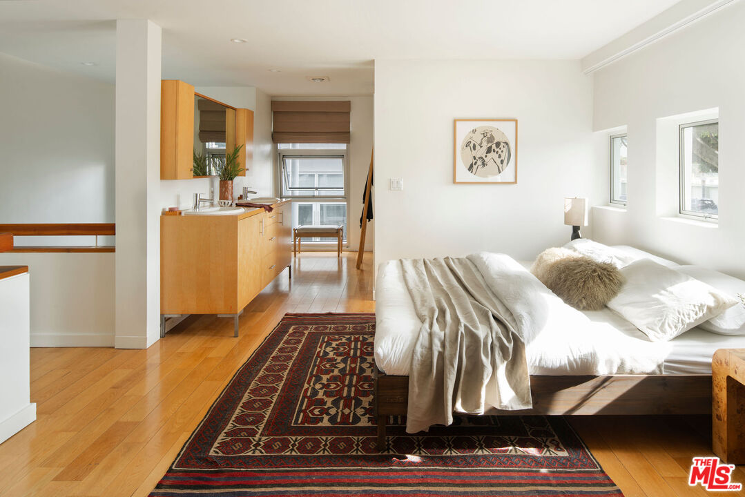 615 Hampton Drive, Unit A101 Venice, CA 90291 - Photo 15 of 24 a living room with furniture rug and wooden floor